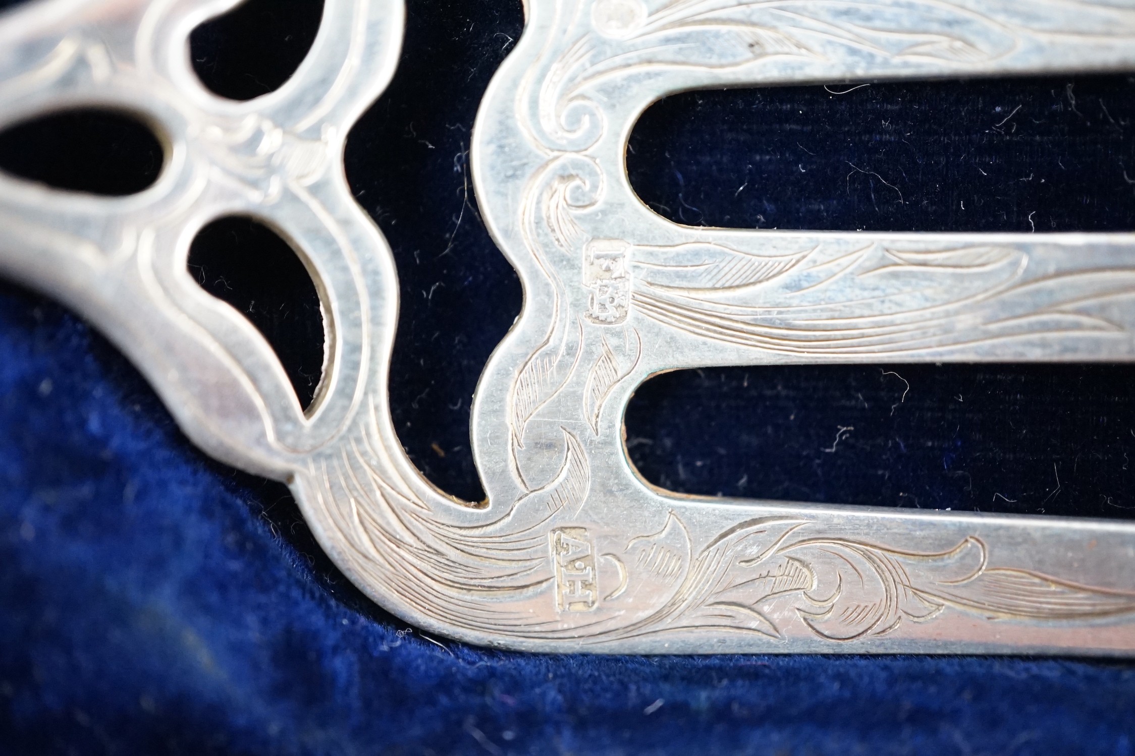 A cased pair of Victorian silver fish servers, by Aaron Hadfield, Sheffield, 1849, with engraved decoration, slice 30.8cm, (loaded handles).